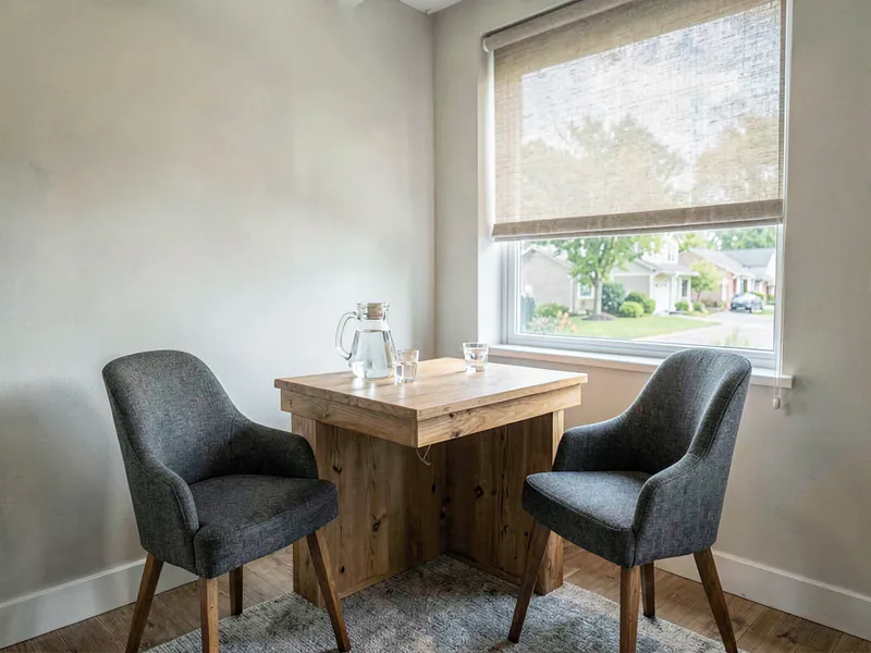 A small suburban broker office corner with a timber desk and two upholstered chairs facing each other